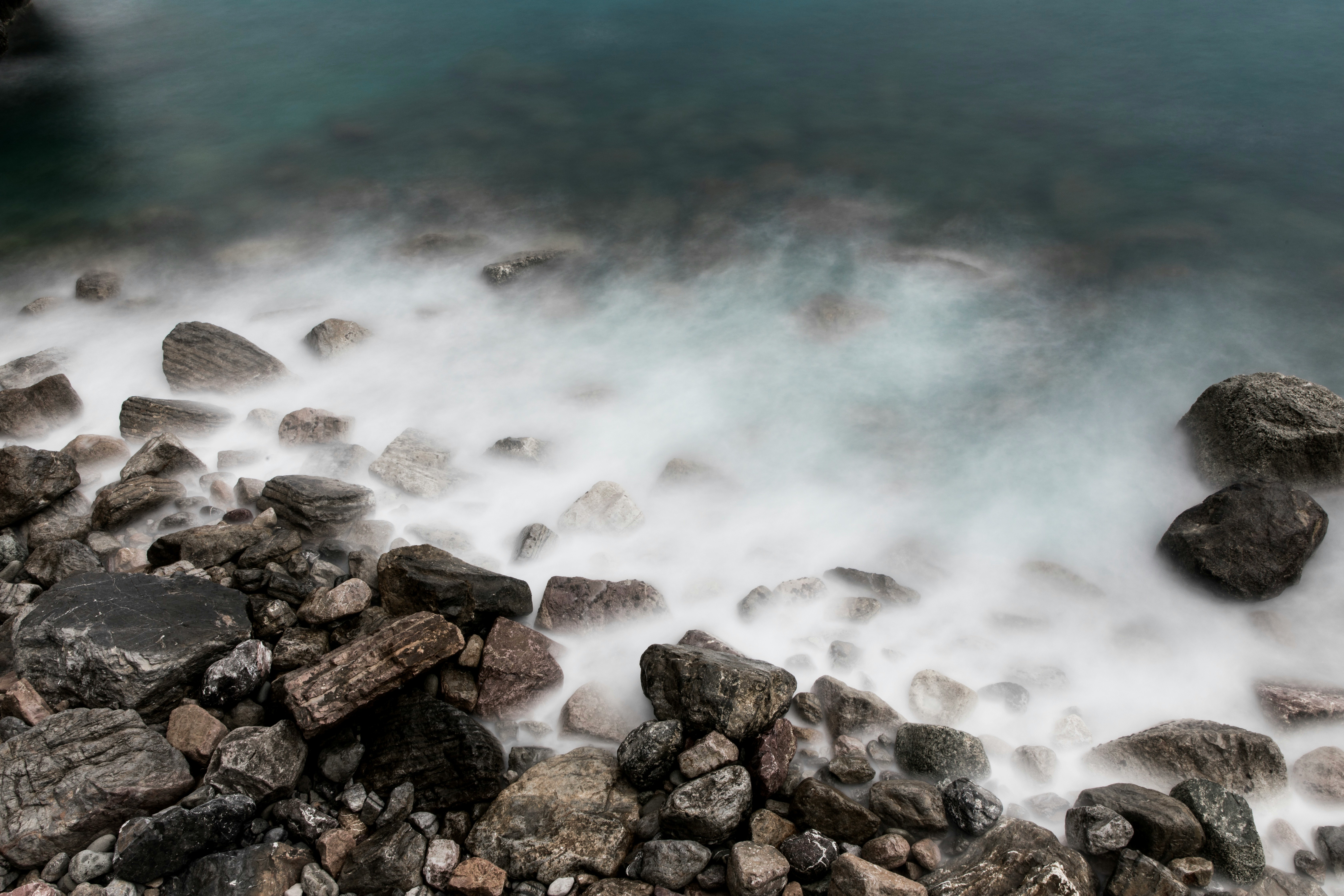 rock formation near body of water during daytime close-up photography